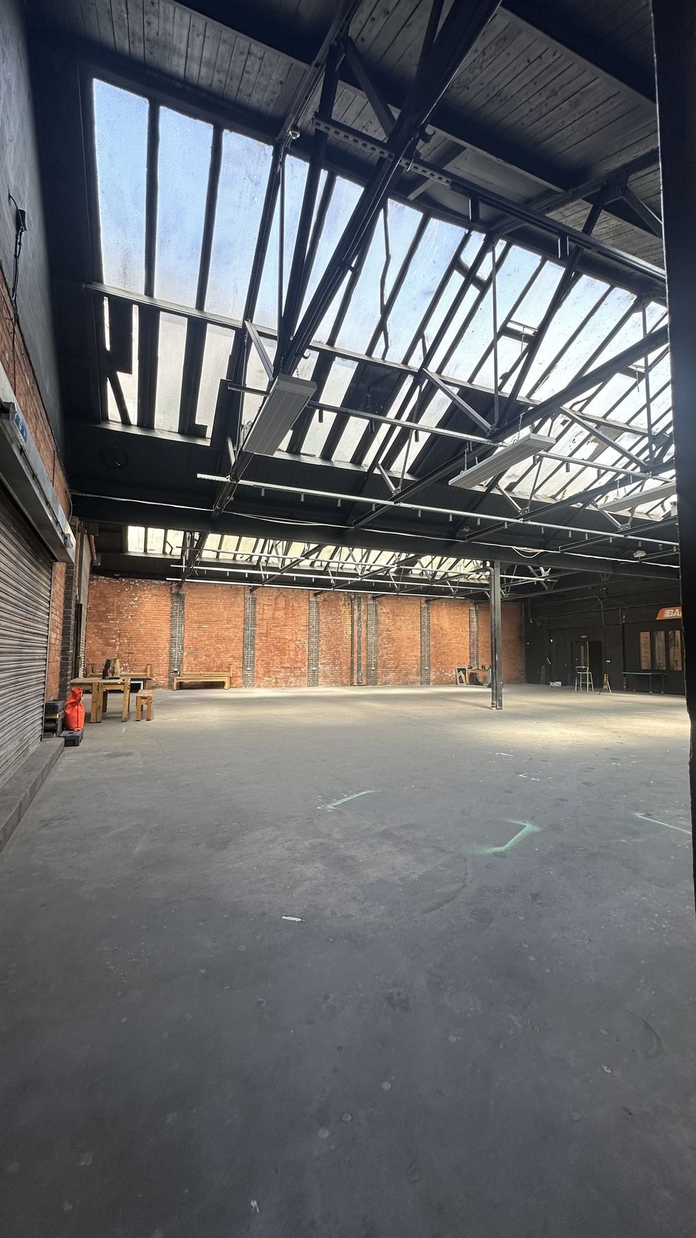 Looking up at the assembly hall's steel roof trusses and skylights