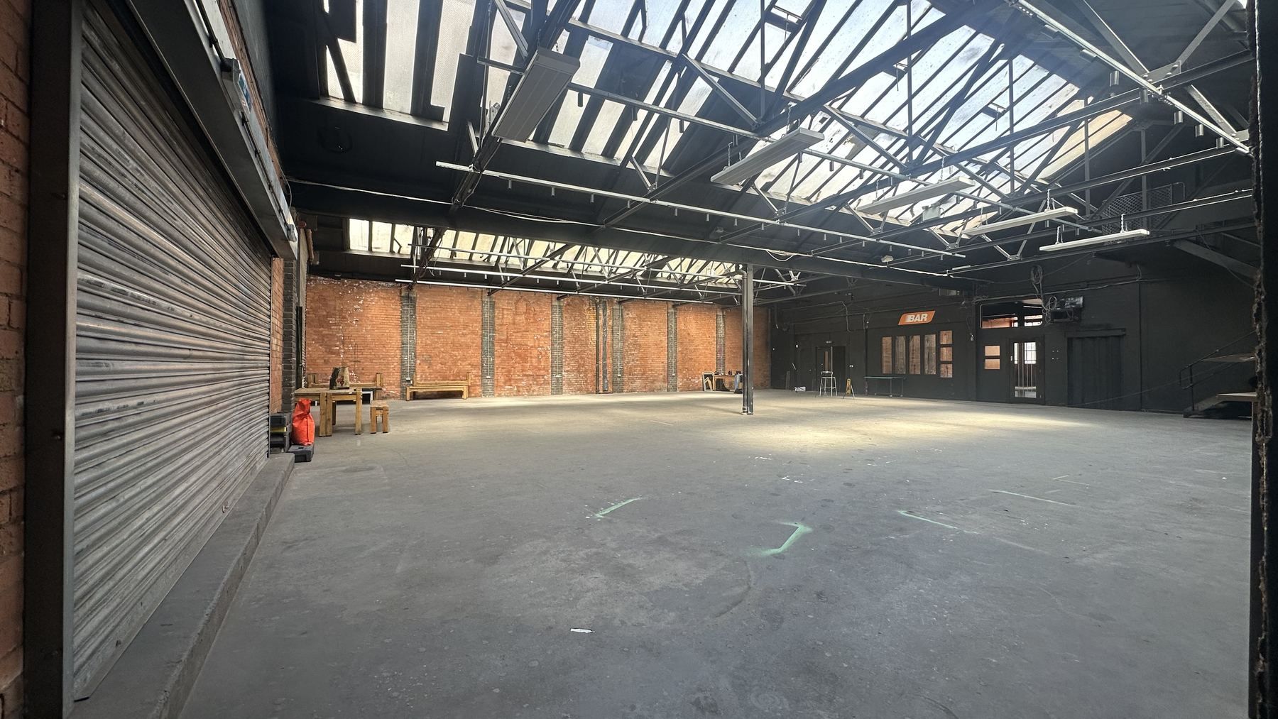 The assembly hall, a long clear span under a saw-tooth roof of skylights